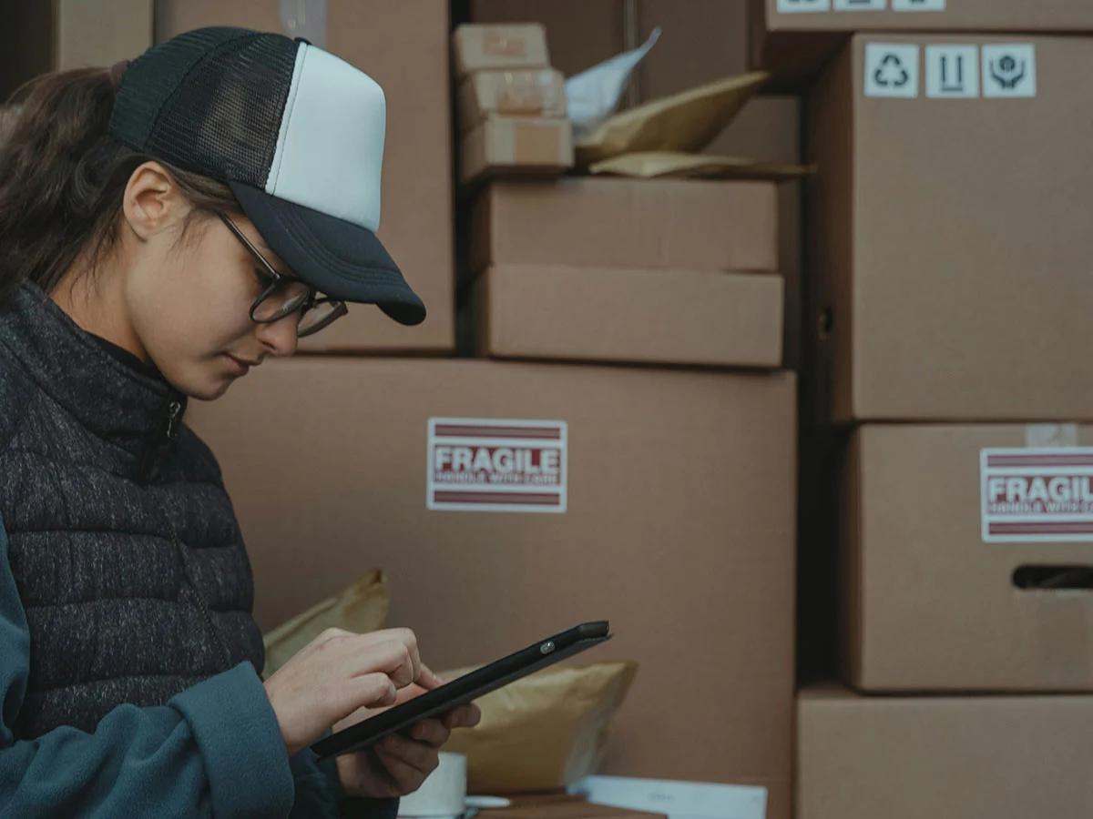 Warehouse worker in front of stacked boxes