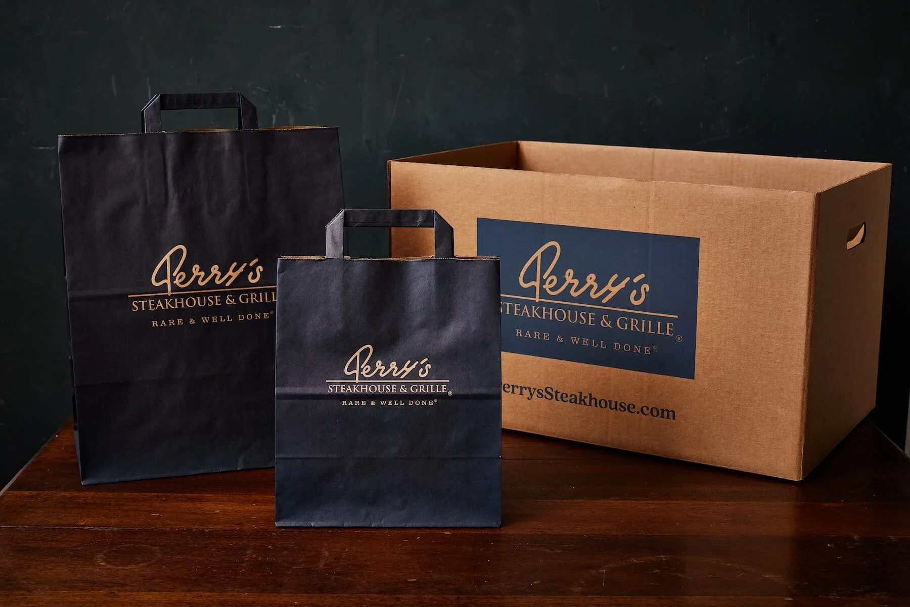 Custom to-go bags and branded takeout containers from Perry’s Steakhouse show how premium packaging elevates the takeout experience.
