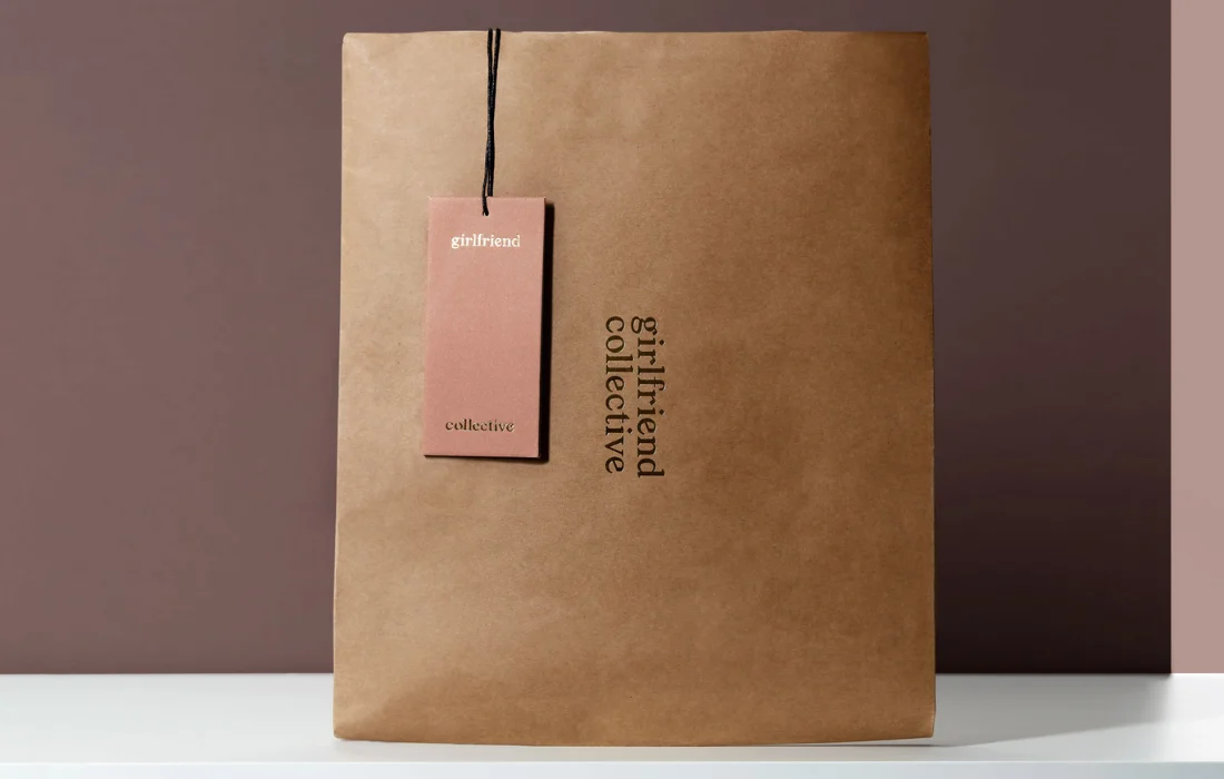Minimalist brown paper mailer with branded tag, showcasing sustainable ecommerce packaging design.