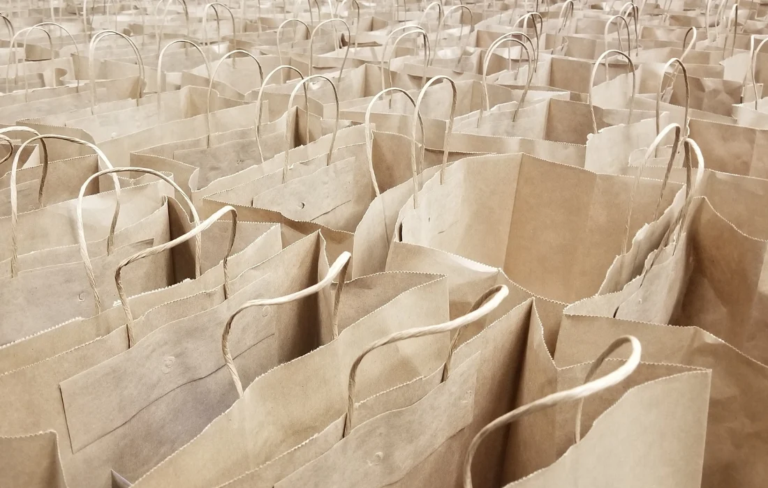 High-angle view of many new, brown paper shopping bags with handles, an alternative to plastic.