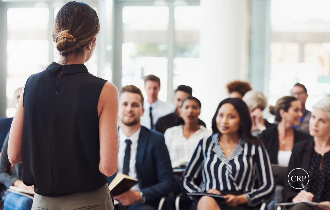 Woman leading a supplier diversity procurement presentation to corporate buyers.