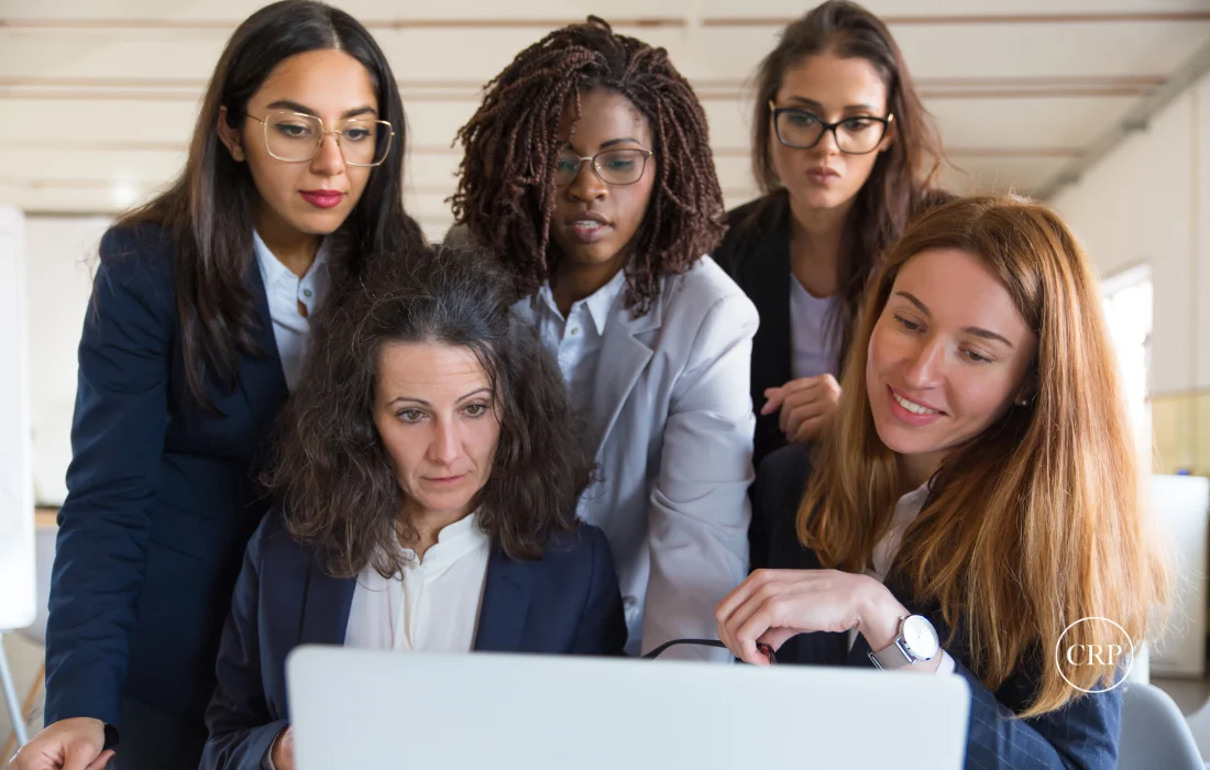 Businesswomen collaborating on packaging supplier diversity program goals.